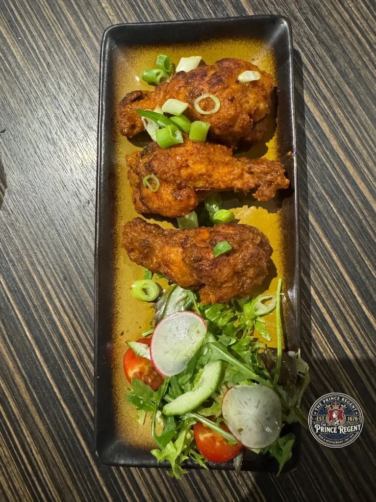 Crispy fried chicken wings with fresh salad